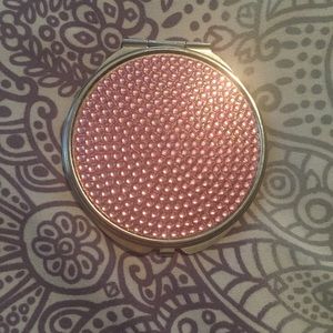 A beautiful pink rhinestoned compact mirror